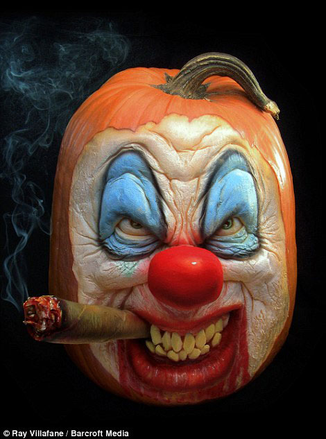 A clown face carved out of a pumpkin by Ray Villafane and his team for Halloween